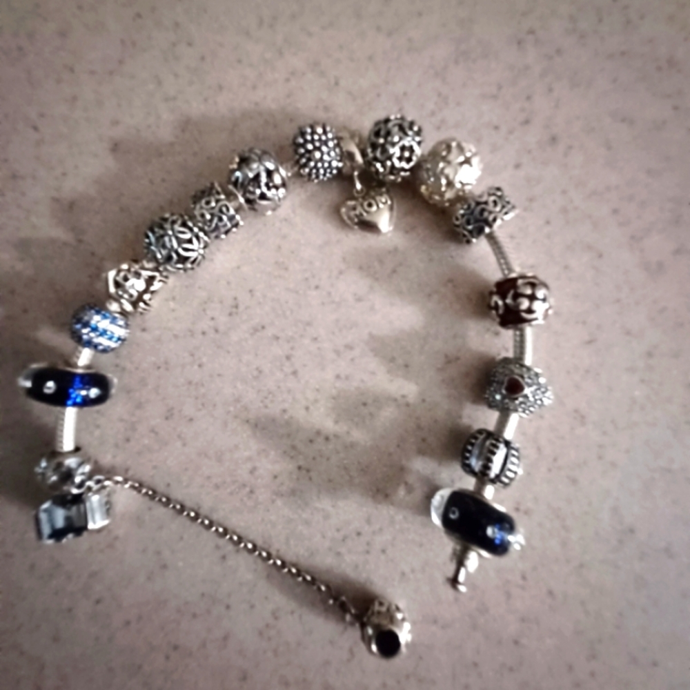 Authentic pandora bracelet with 15 charms and safety chain like new